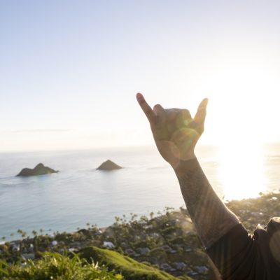 shaka over a sunrise